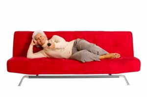 lady lying on a red sofa, relaxing